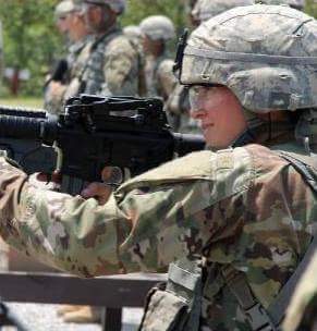 Tabatha Pfarner shooting a grenade launcher in basic military combat training.